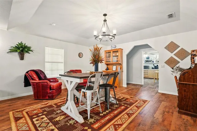 a living room with dining room and wooden floor