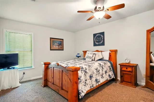 a bedroom with bed and a flat screen tv