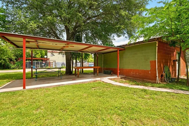 a backyard of a house with yard and outdoor seating