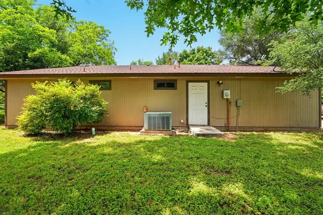 a view of a backyard with large trees