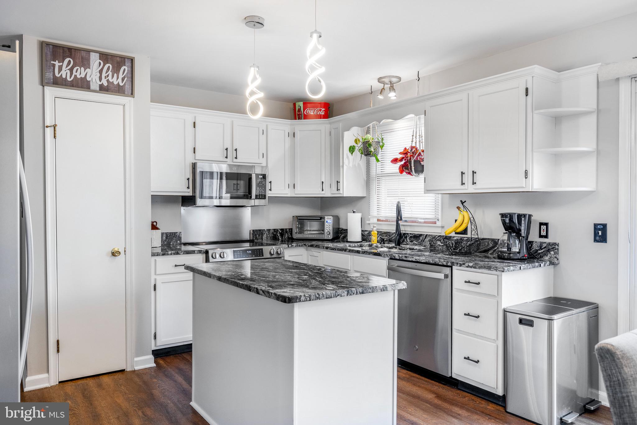 303 Gray Mt Circle Elkton, MD 21921 - Photo 13 of 35 a kitchen with stainless steel appliances granite countertop a sink stove and refrigerator