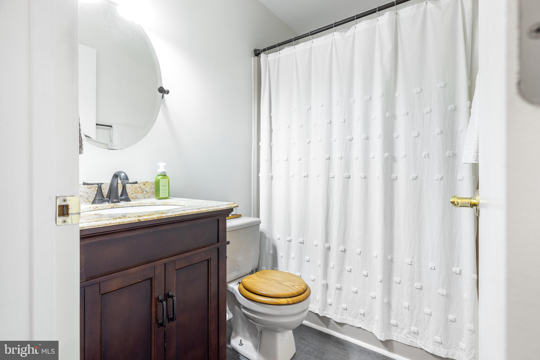 303 Gray Mt Circle Elkton, MD 21921 - Photo 19 of 35 a bathroom with a granite countertop sink toilet and a mirror