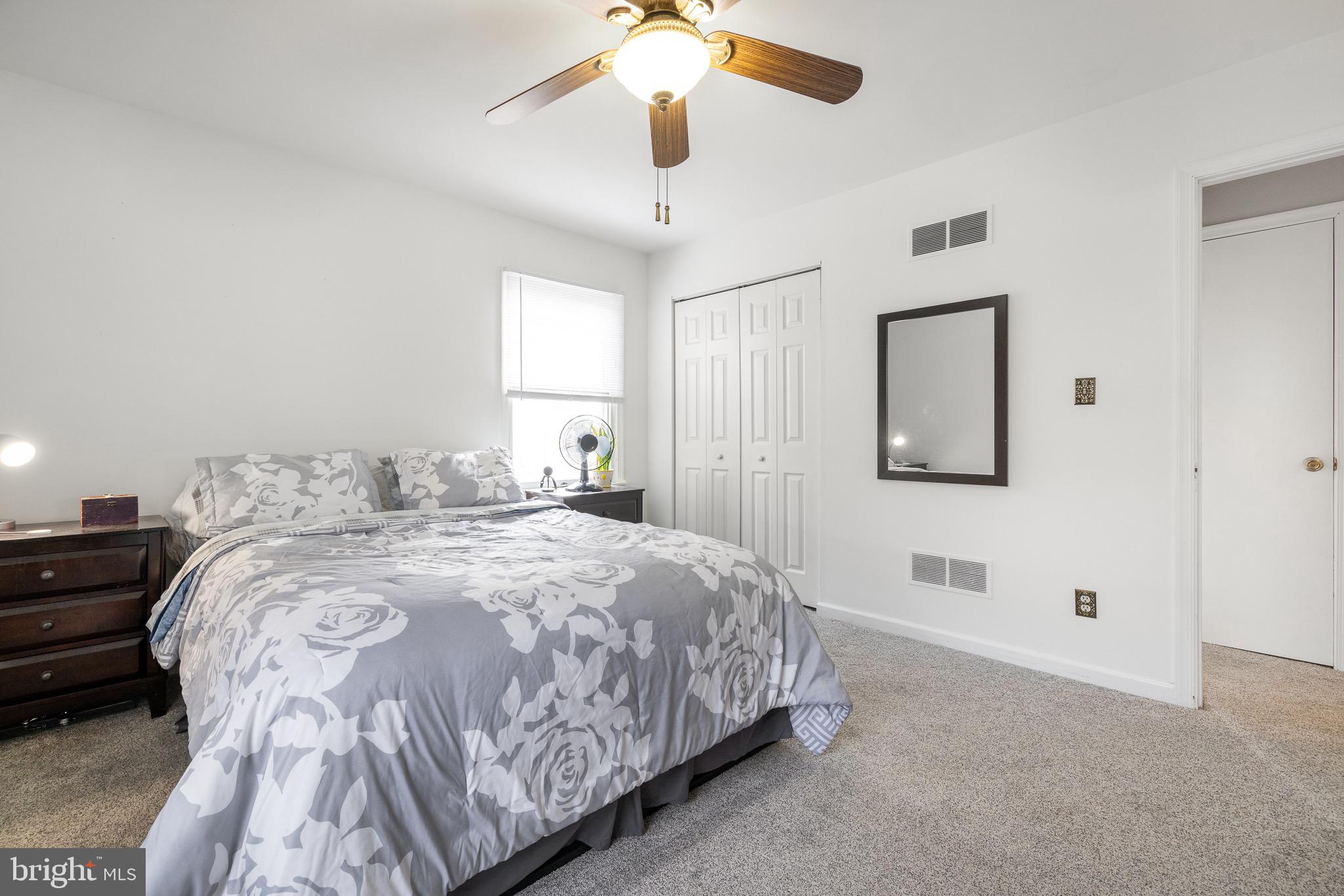 303 Gray Mt Circle Elkton, MD 21921 - Photo 21 of 35 a bedroom with a bed and a chandelier