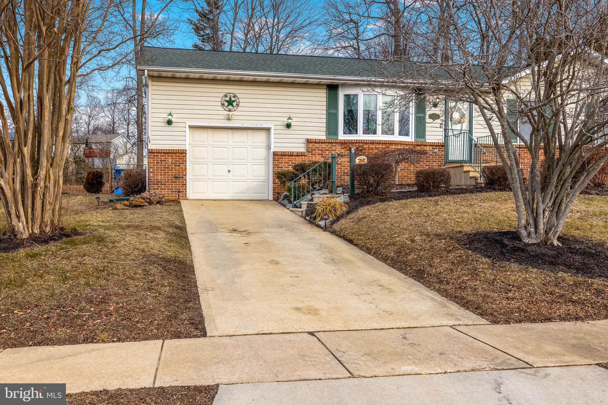303 Gray Mt Circle Elkton, MD 21921 - Photo 7 of 35 a front view of a house with a yard and garage