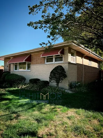 a front view of house with yard and outdoor seating