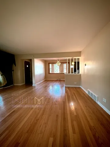 a view of a living room with hardwood floor