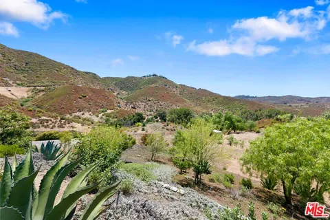 an aerial view of house with mountain view