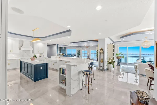 a living room with furniture a flat screen tv and a large window