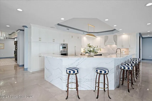 a dining room with furniture potted plants and wooden floor