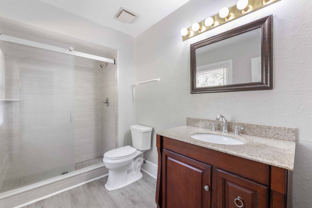 4601 Ritch Haven Road Columbus, GA 31909 - Photo 15 of 24 a bathroom with a toilet a sink a vanity and mirror