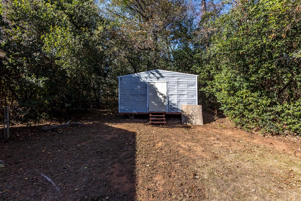 4601 Ritch Haven Road Columbus, GA 31909 - Photo 16 of 24 a wooden house with trees in front of it