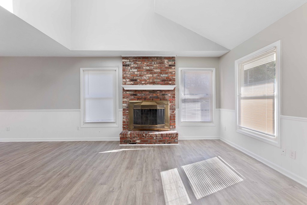4601 Ritch Haven Road Columbus, GA 31909 - Photo 3 of 24 a view of a livingroom with wooden floor a fireplace and windows