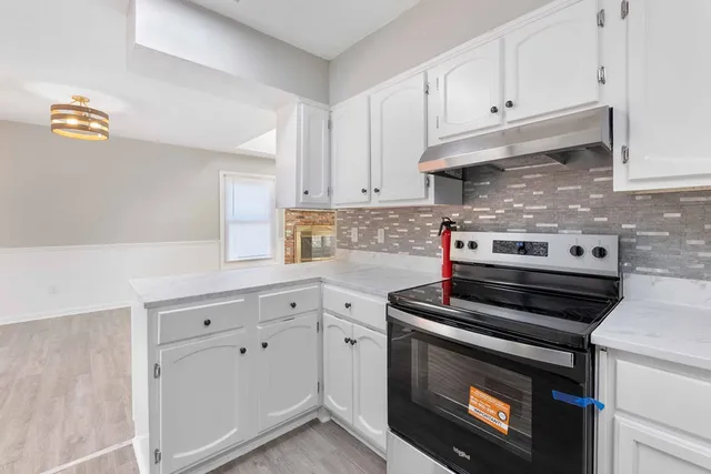 a kitchen with cabinets and appliances