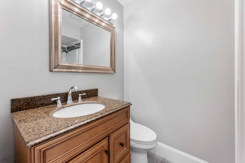 4601 Ritch Haven Road Columbus, GA 31909 - Photo 10 of 24 a bathroom with a granite countertop sink a toilet and mirror