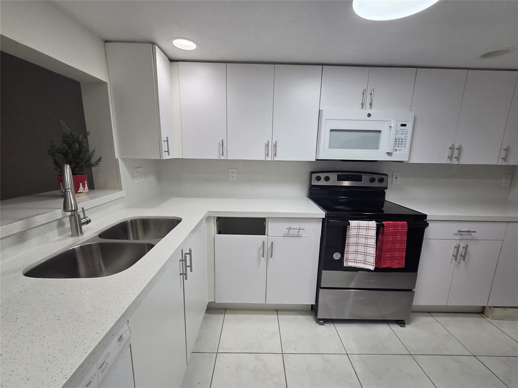 7901 South Colony Circle, Unit 101 Tamarac, FL 33321 - Photo 12 of 28 a kitchen with a sink and cabinets