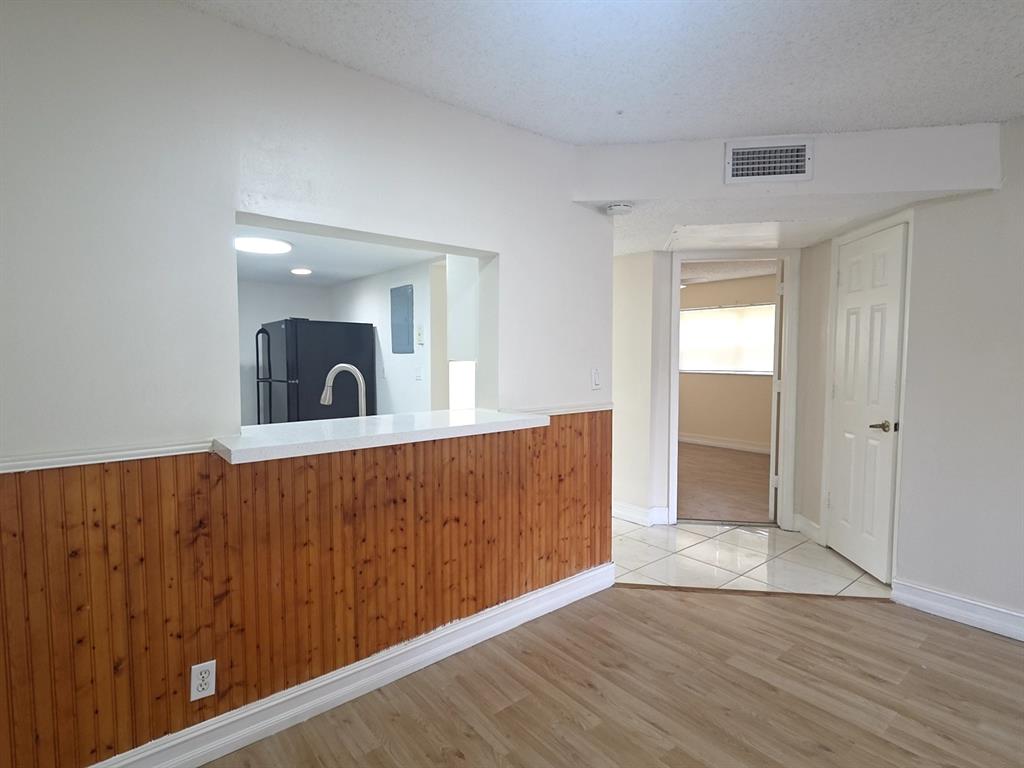 7901 South Colony Circle, Unit 101 Tamarac, FL 33321 - Photo 8 of 28 a view of an empty room with wooden floor
