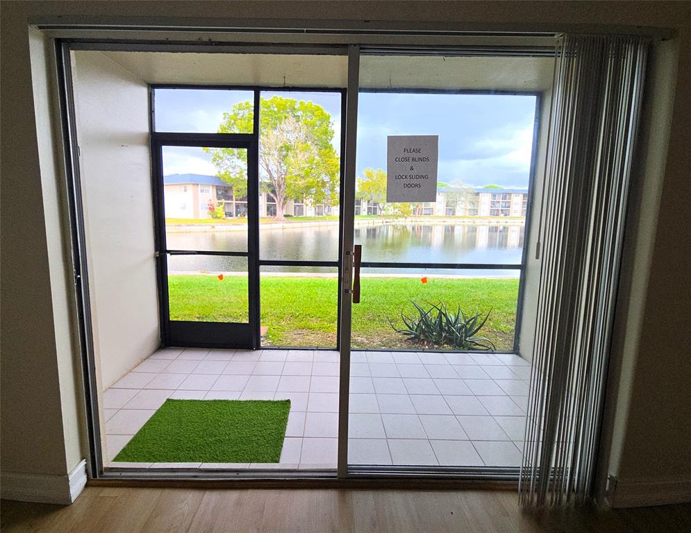 7901 South Colony Circle, Unit 101 Tamarac, FL 33321 - Photo 10 of 28 a view of an empty room with a floor to ceiling window