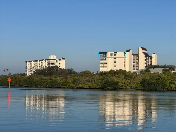 a view of a large body of water with a building in the background