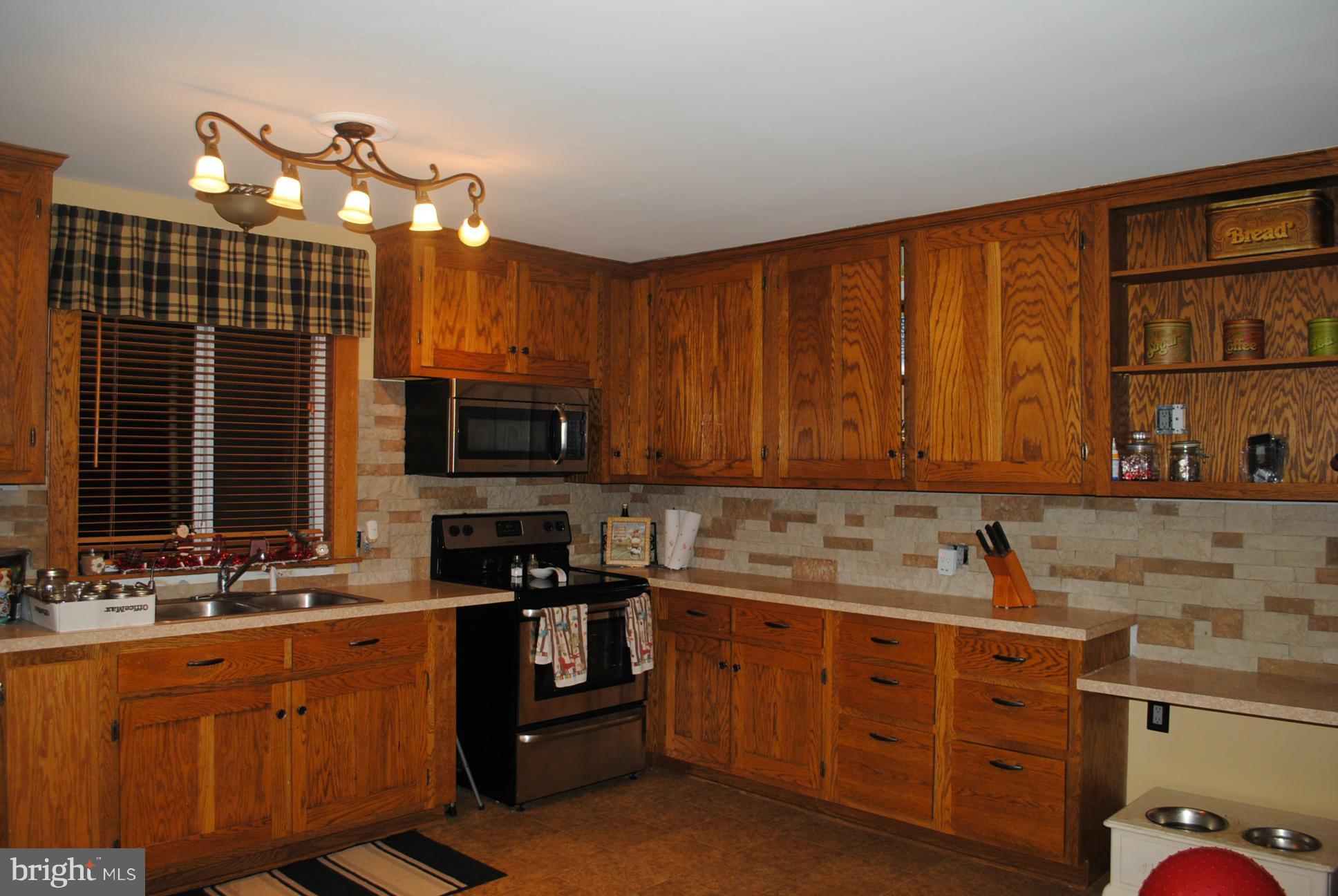 26 Messick Road Strasburg, VA 22657 - Photo 6 of 28 a kitchen with stainless steel appliances granite countertop a sink stove and cabinets