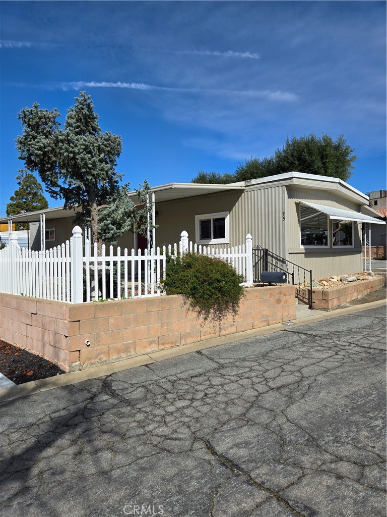 10320 Calimesa Boulevard, Unit 75 Calimesa, CA 92320 - Photo 1 of 1 a view of a house with a yard