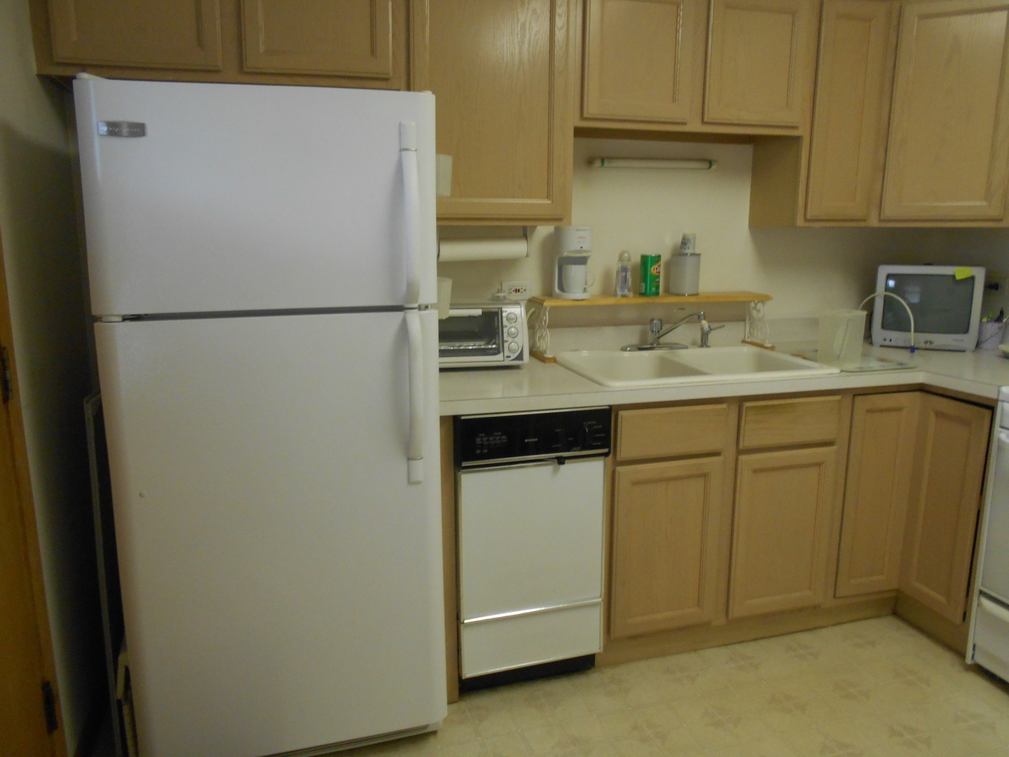 2000 Parkside Drive, Unit G2 Park Ridge, IL 60068 - Photo 8 of 12 a kitchen with a sink a refrigerator and cabinets