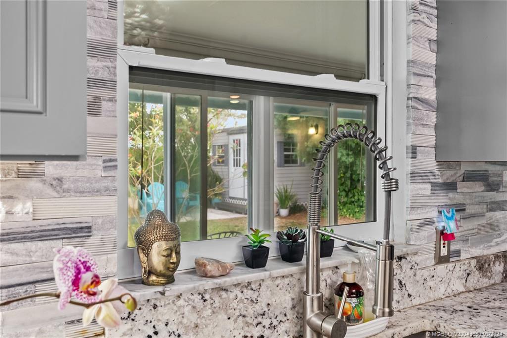 9182 Southeast Apollo Street Hobe Sound, FL 33455 - Photo 11 of 26 a living room filled with furniture and a potted plant