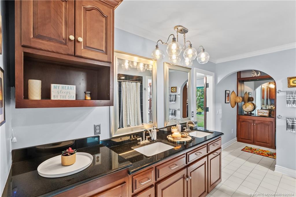 9182 Southeast Apollo Street Hobe Sound, FL 33455 - Photo 14 of 26 a bathroom with a sink granite and a mirror