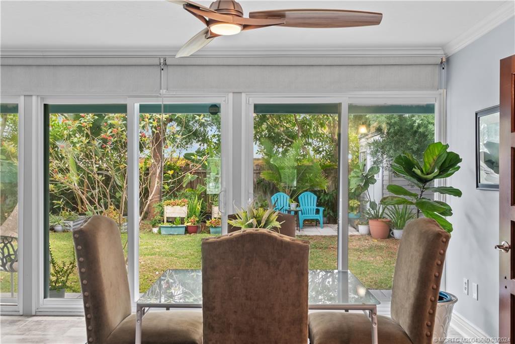9182 Southeast Apollo Street Hobe Sound, FL 33455 - Photo 17 of 26 a living room with patio furniture and garden view