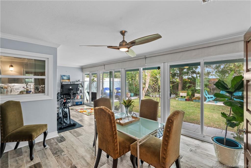 9182 Southeast Apollo Street Hobe Sound, FL 33455 - Photo 18 of 26 a view of a dining room with furniture window and outside view