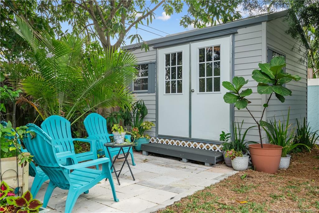 9182 Southeast Apollo Street Hobe Sound, FL 33455 - Photo 21 of 26 a view of a house with backyard sitting area and entertaining space