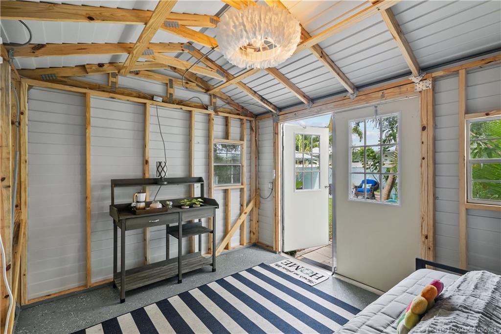 9182 Southeast Apollo Street Hobe Sound, FL 33455 - Photo 23 of 26 a reading room with wooden floor and furniture