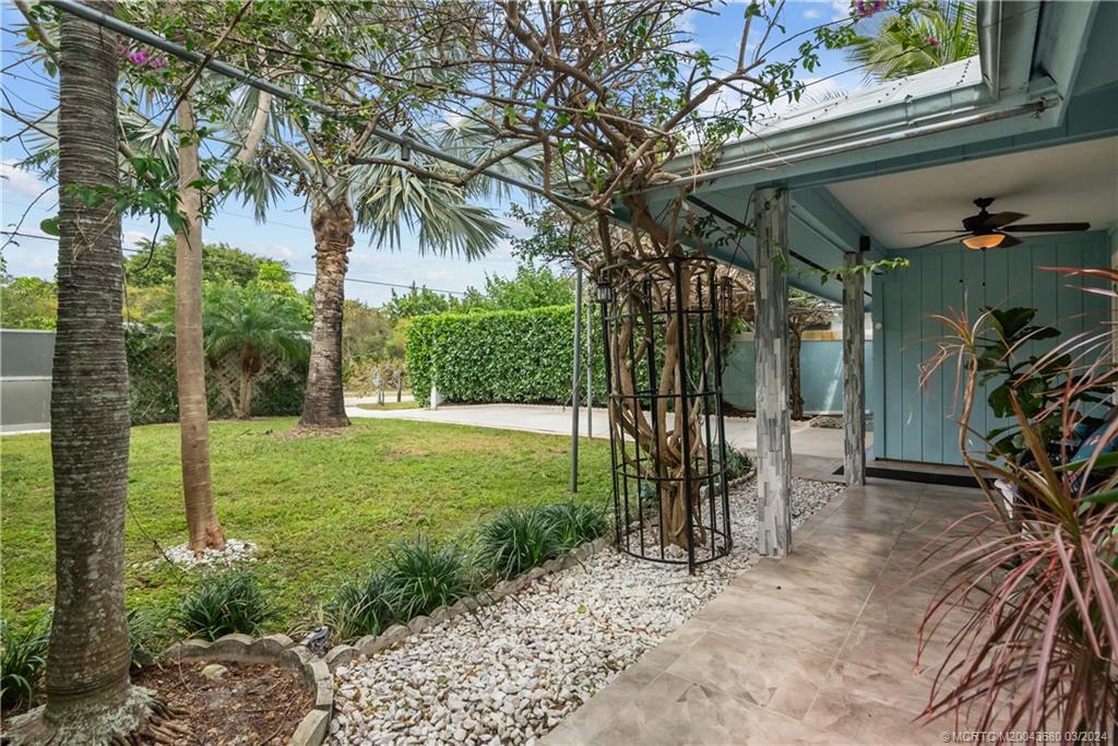 9182 Southeast Apollo Street Hobe Sound, FL 33455 - Photo 3 of 26 a view of a porch with a yard