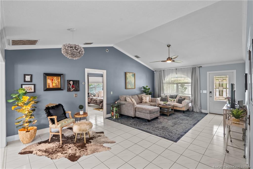 9182 Southeast Apollo Street Hobe Sound, FL 33455 - Photo 7 of 26 a living room with furniture kitchen view and a window