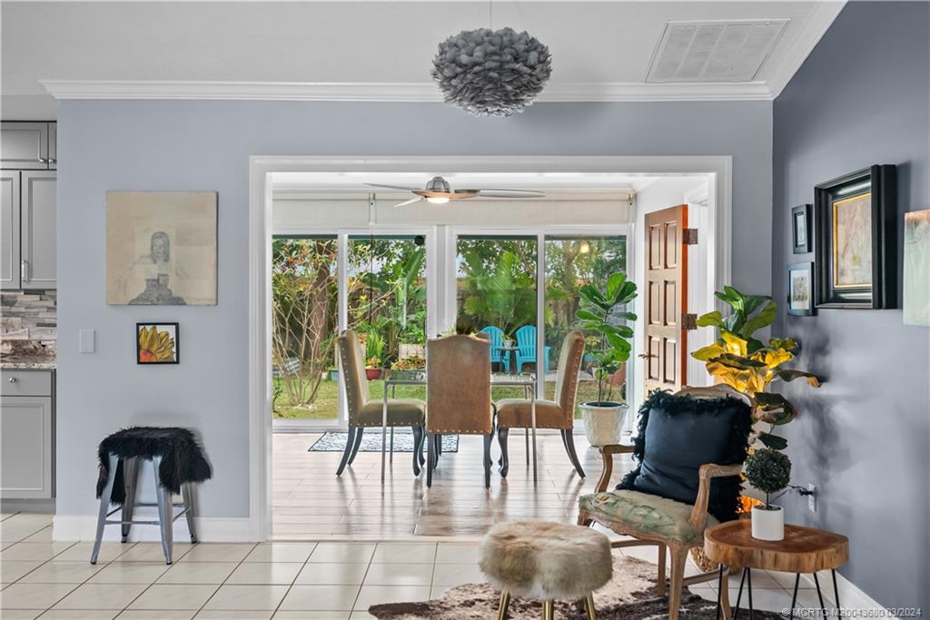 9182 Southeast Apollo Street Hobe Sound, FL 33455 - Photo 8 of 26 a living room with furniture and floor to ceiling windows
