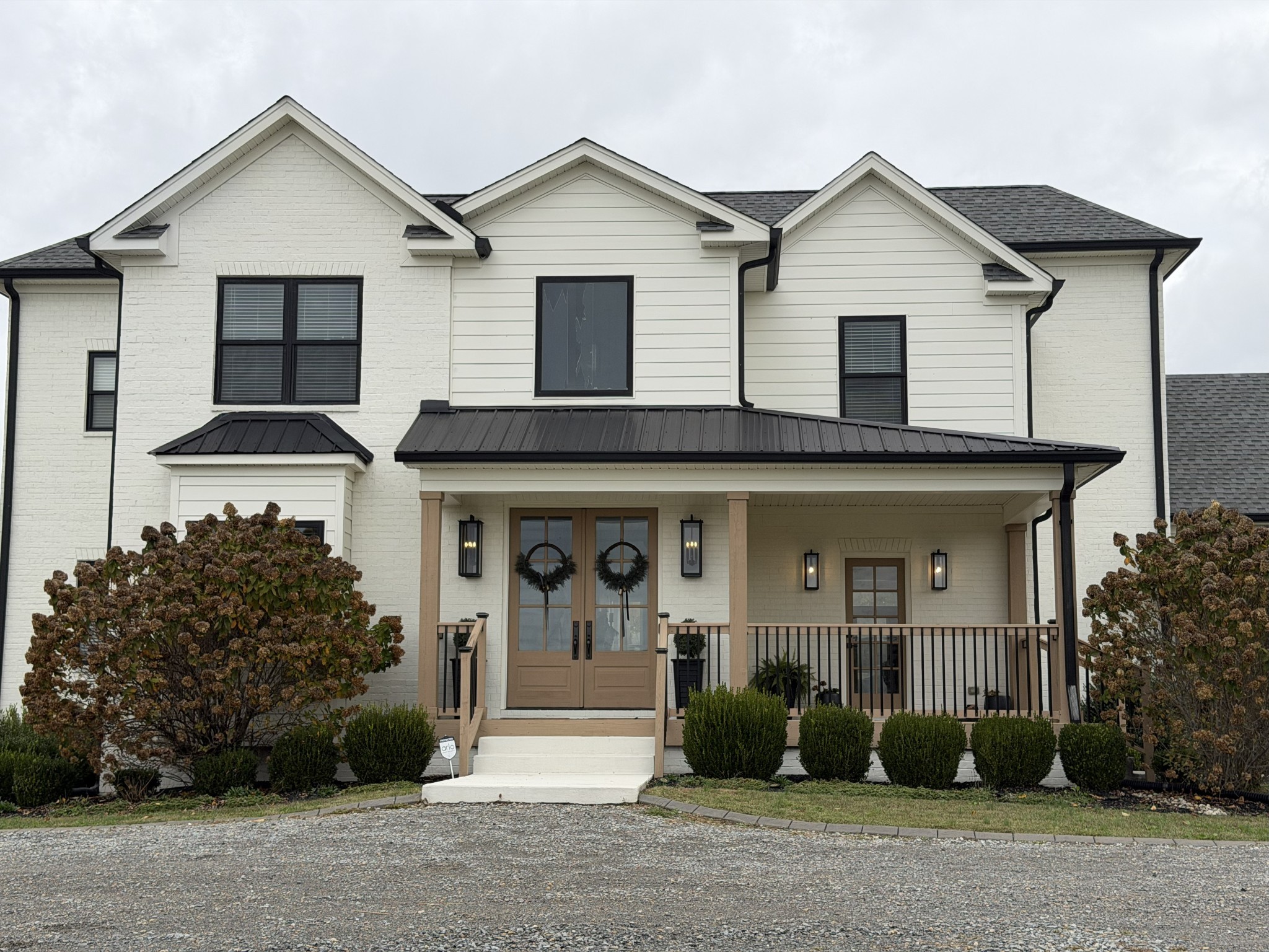 7314 Dug Hill Road Bon Aqua, TN 37025 - Photo 78 of 79 a view of a white house with large windows and a small yard