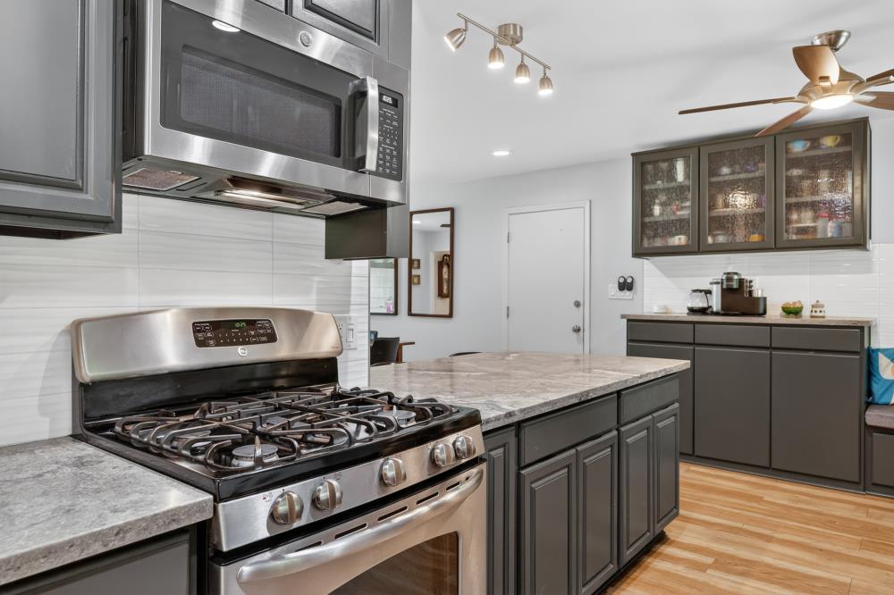 4831 Jan Drive Carmichael, CA 95608 - Photo 13 of 69 a kitchen with stainless steel appliances granite countertop a stove and a microwave