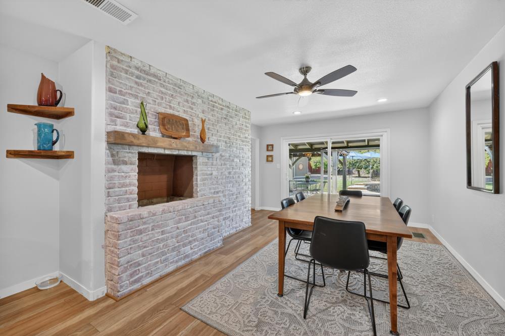 4831 Jan Drive Carmichael, CA 95608 - Photo 15 of 69 a dining room with furniture a flat screen tv and a fireplace
