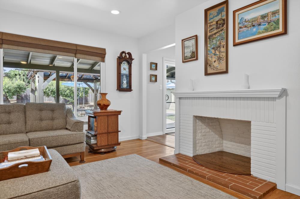 4831 Jan Drive Carmichael, CA 95608 - Photo 20 of 69 a living room with furniture a fireplace and a floor to ceiling window