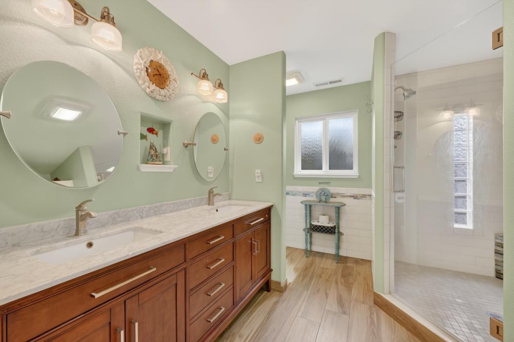 4831 Jan Drive Carmichael, CA 95608 - Photo 28 of 69 a spacious bathroom with a double vanity sink a large mirror and a shower