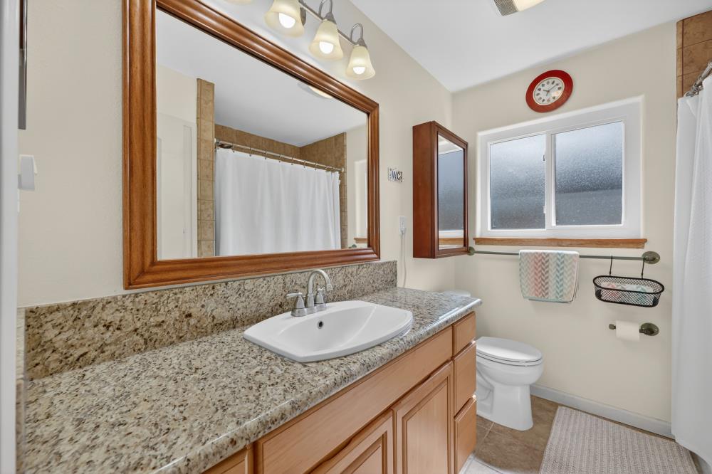 4831 Jan Drive Carmichael, CA 95608 - Photo 33 of 69 a bathroom with a granite countertop sink and a mirror