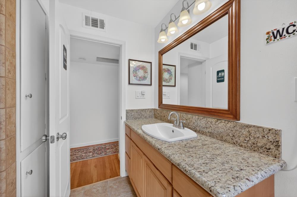 4831 Jan Drive Carmichael, CA 95608 - Photo 34 of 69 a bathroom with a granite countertop sink and a mirror