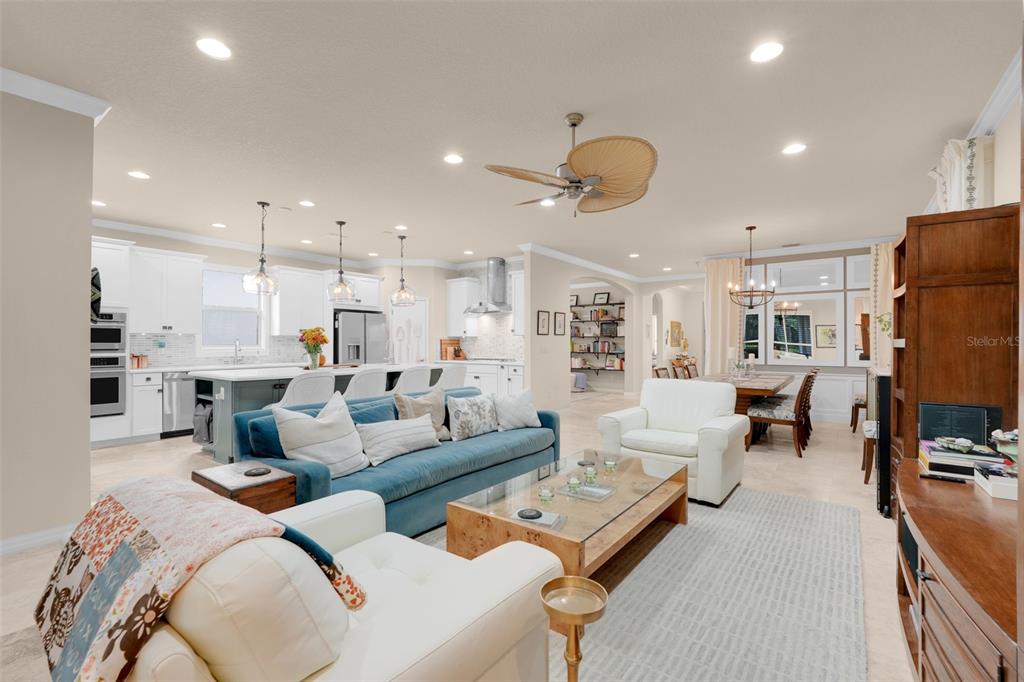 1038 Timbervale Trail Clermont, FL 34715 - Photo 24 of 54 a living room with furniture kitchen view and a chandelier