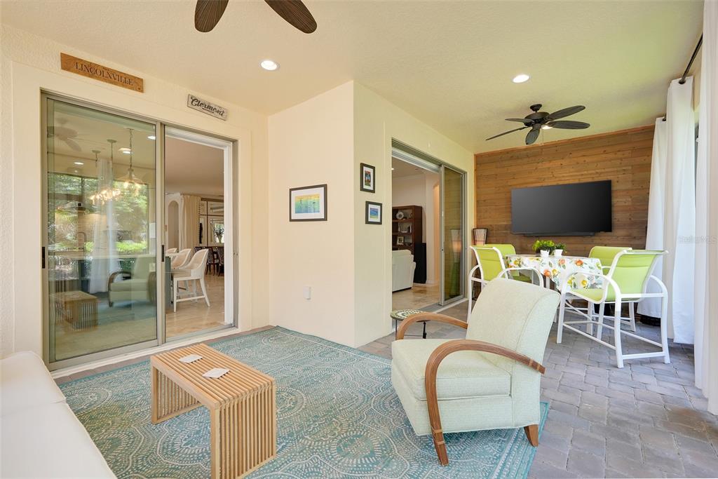1038 Timbervale Trail Clermont, FL 34715 - Photo 34 of 54 a living room with furniture a flat screen tv and a chandelier