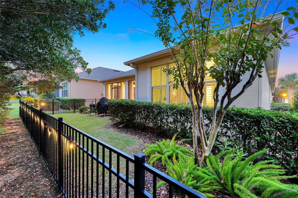 1038 Timbervale Trail Clermont, FL 34715 - Photo 42 of 54 a view of a house with a flower garden
