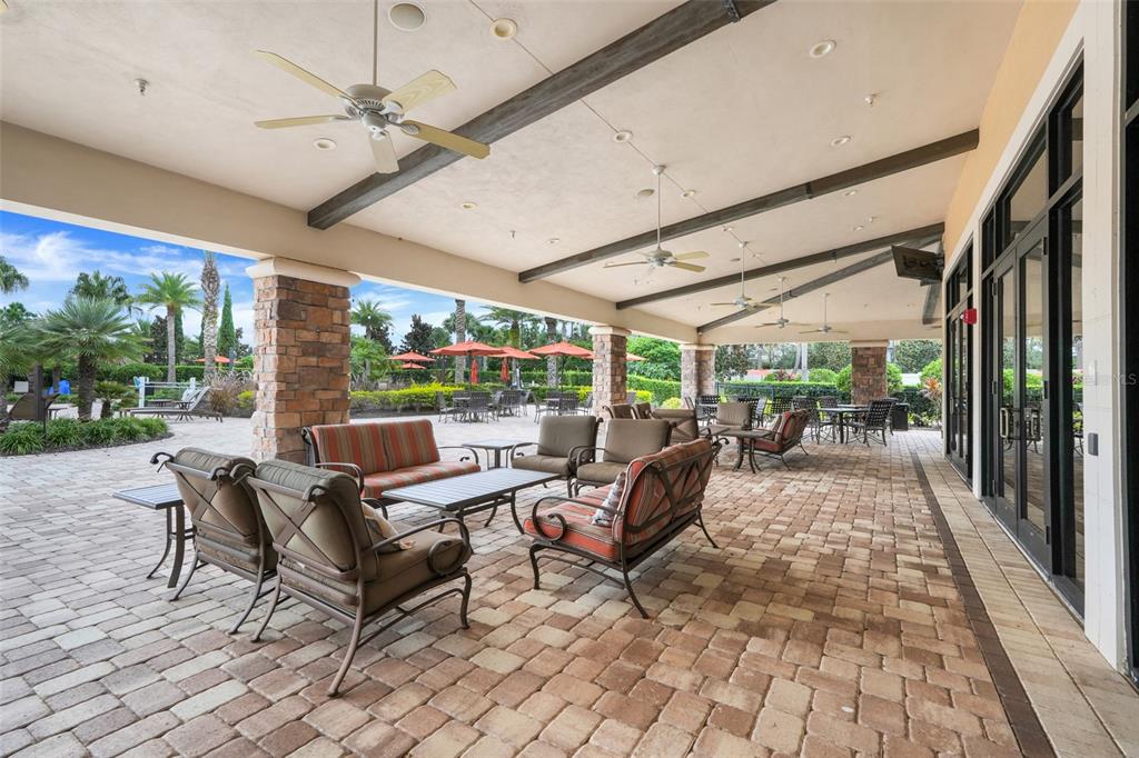 1038 Timbervale Trail Clermont, FL 34715 - Photo 45 of 54 a living room with patio furniture and garden view