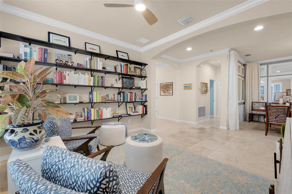 1038 Timbervale Trail Clermont, FL 34715 - Photo 9 of 54 a living room with furniture and a book shelf
