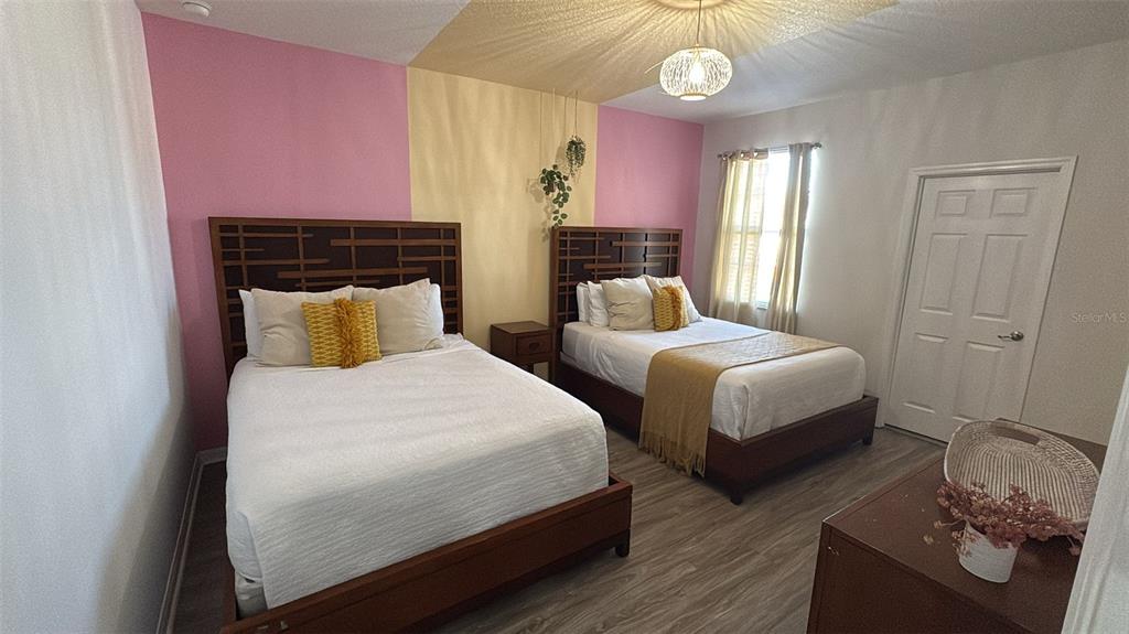 4445 Shiva Loop Kissimmee, FL 34746 - Photo 12 of 33 a bedroom with two beds and a window