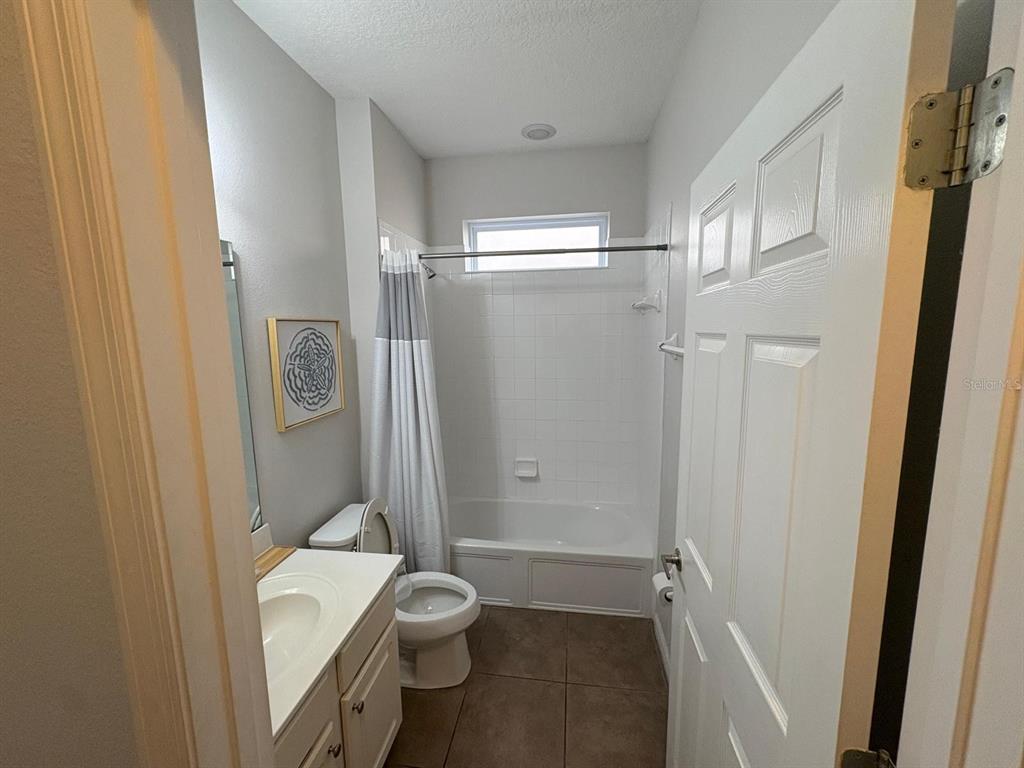4445 Shiva Loop Kissimmee, FL 34746 - Photo 5 of 33 a bathroom with a toilet and a shower