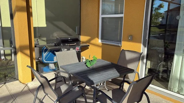 a view of balcony and dining area with furniture
