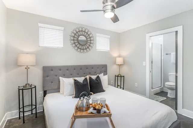 a bedroom with a bed and a table